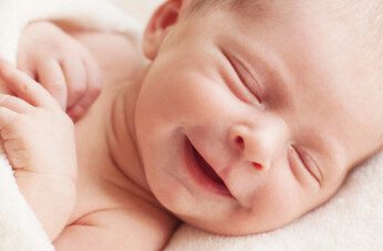 Why do babies smile in their sleep